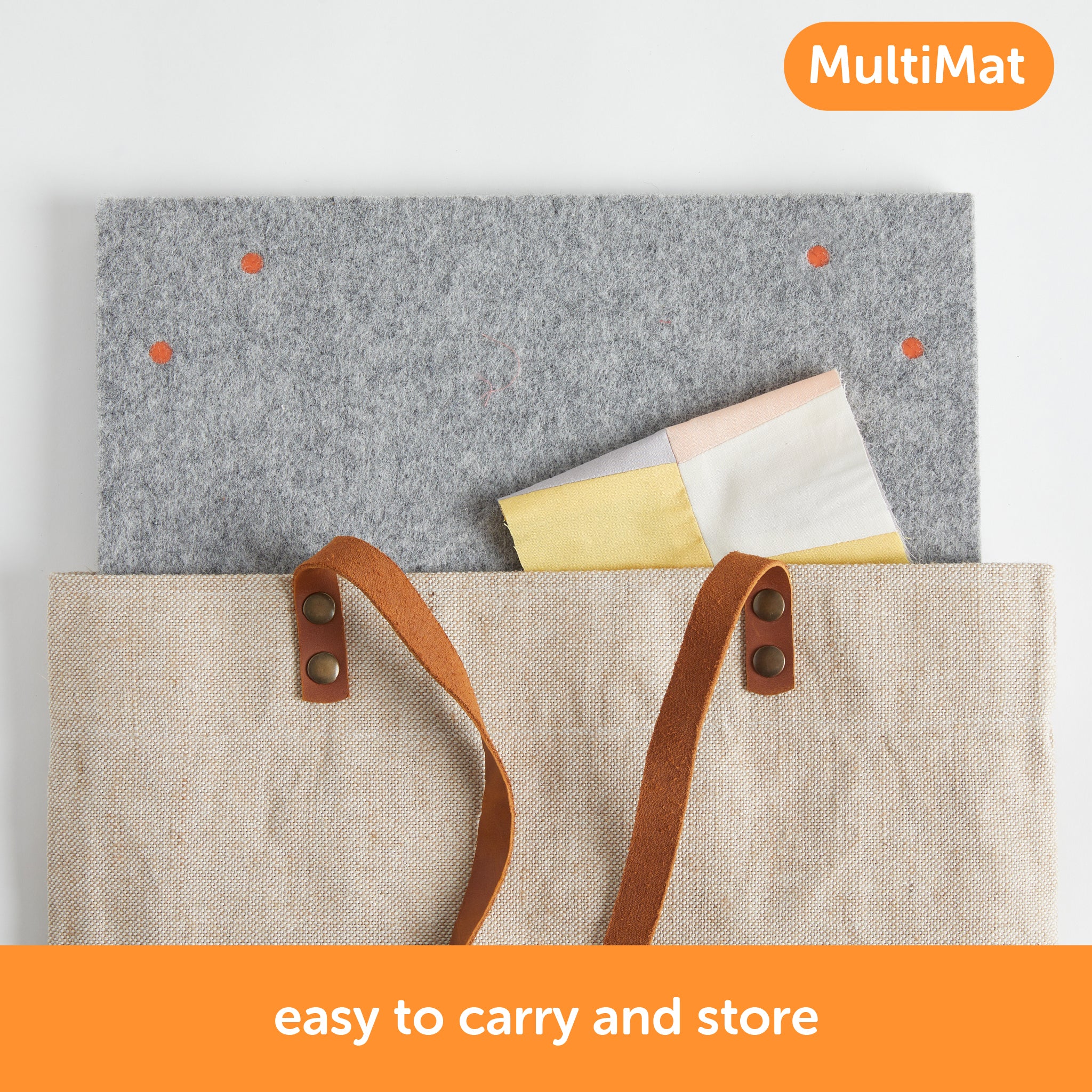 Content description ="The 14 x 14 inch Oliso MultiMat wool pressing mat being placed into a bag for easy transport and storage. Bag not included."