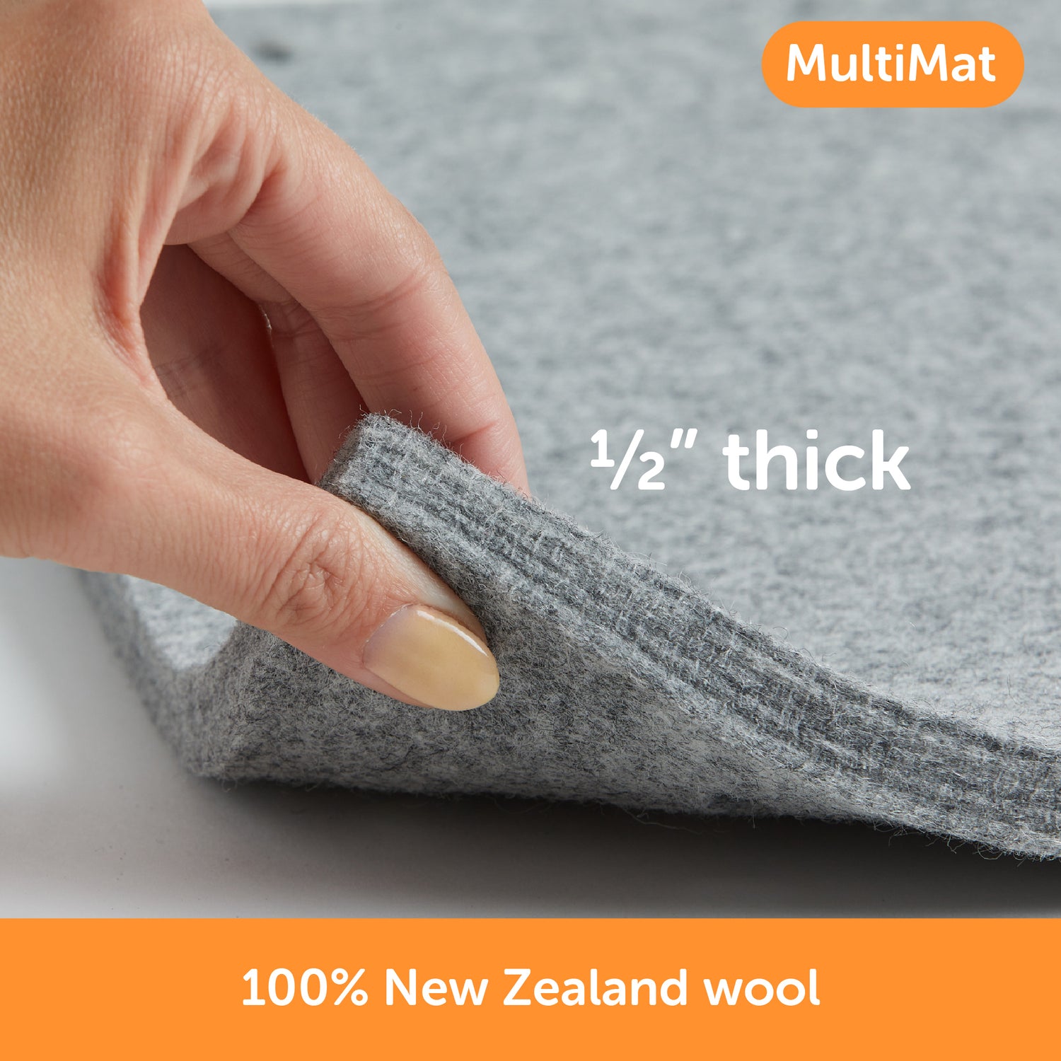 Content description =&quot;Close-up view of Oliso’s 100% New Zealand wool pressing mat showing its ½-inch thickness between fingers&quot;&gt;