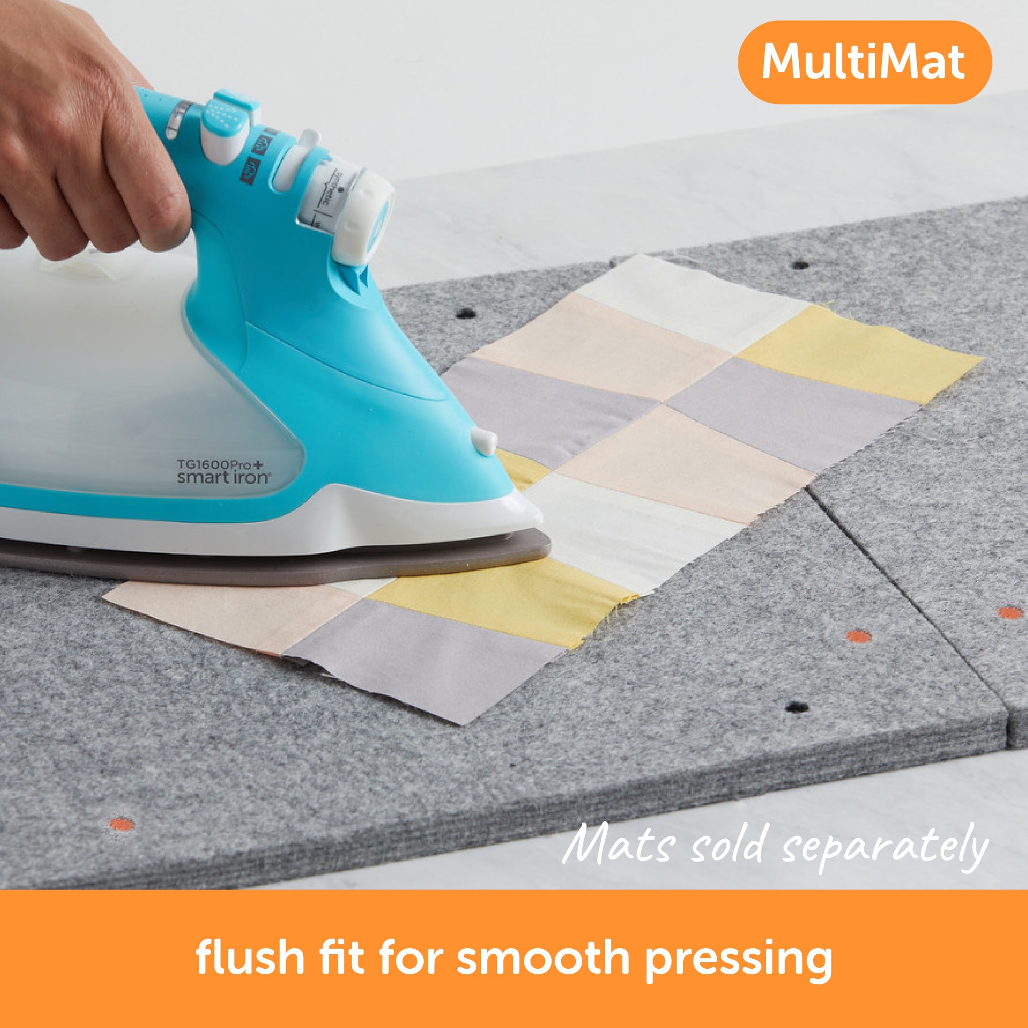 Content description ="Oliso Smart Iron pressing a quilt square on two joined MultiMat wool mats with a flush fit for smooth pressing. Both iron and mats are sold separately.">
