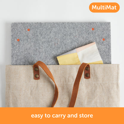 Content description =&quot;The 14 x 14 inch Oliso MultiMat wool pressing mat being placed into a bag for easy transport and storage. Bag not included.&quot;