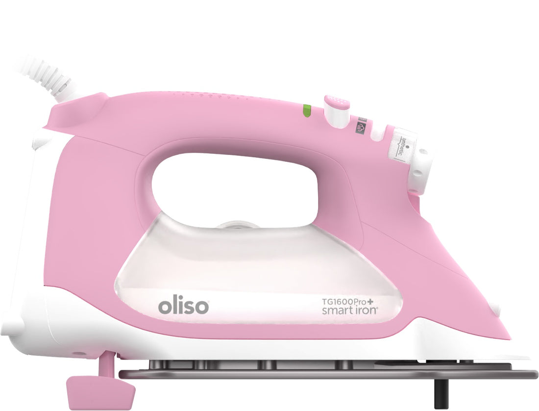 Pink ProPlus Smart Iron raised on it legs .