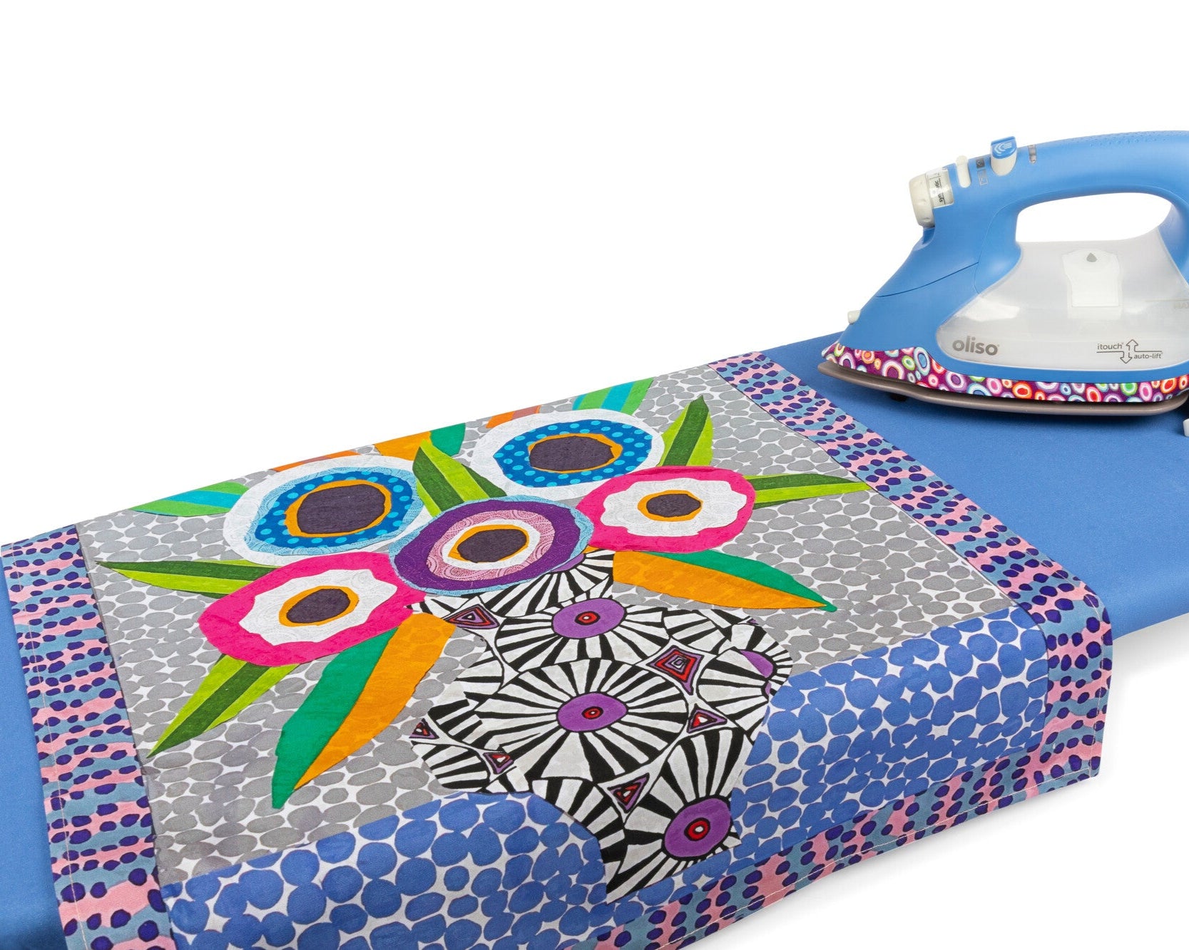 Kaffe Fassett tea towel and pressing cloth by Oliso, shown next to the Kaffe Smart iron by Oliso.