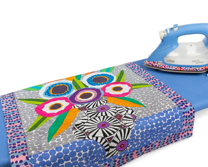 Kaffe Fassett tea towel and pressing cloth by Oliso, shown next to the Kaffe Smart iron by Oliso.