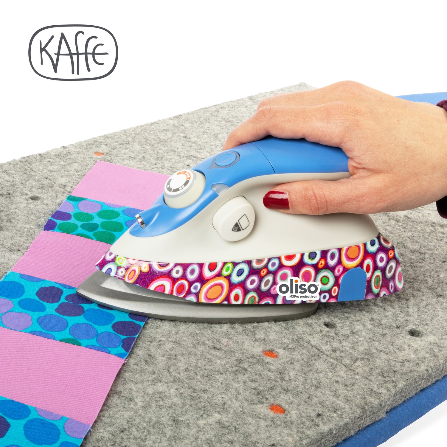 The Kaffe x Oliso M3Pro project Iron, featuring vibrant Kaffe Fassett signature patterns, specifically designed with quilting and sewing in mind.