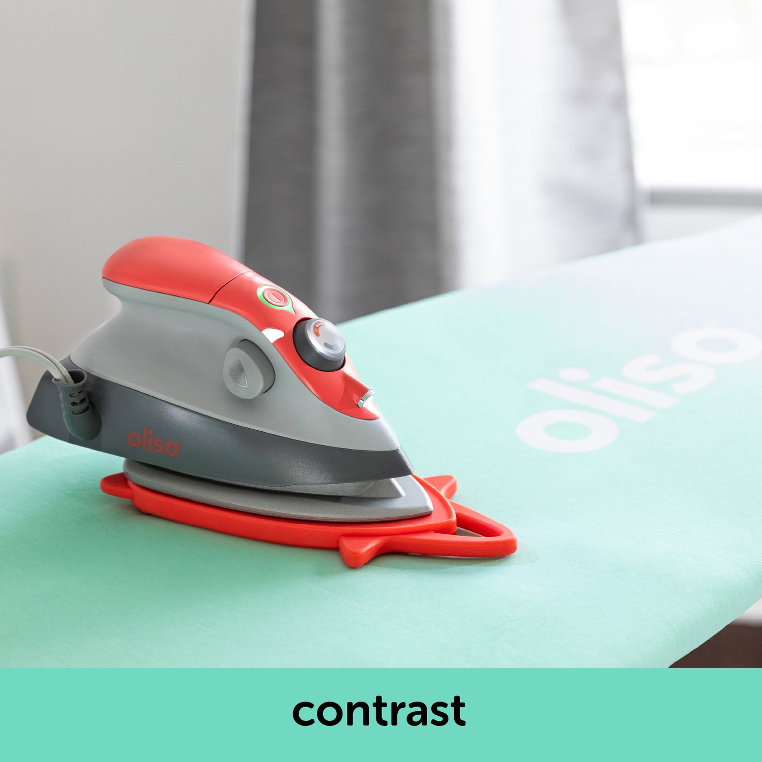 Image showing how the coral oliso M3Pro project iron contrasts with the aqau ironing board cover. Each is sold separately.