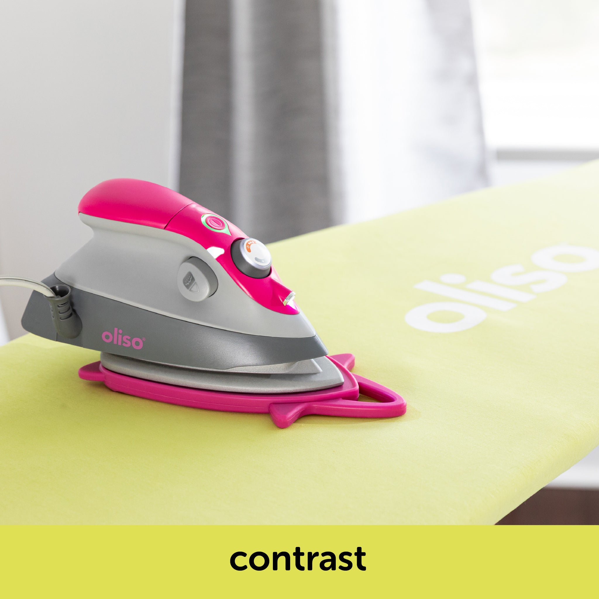 Image showing how the raspberry oliso M3Pro project iron contrast with the pistachio ironing board cover. Each is sold separately.