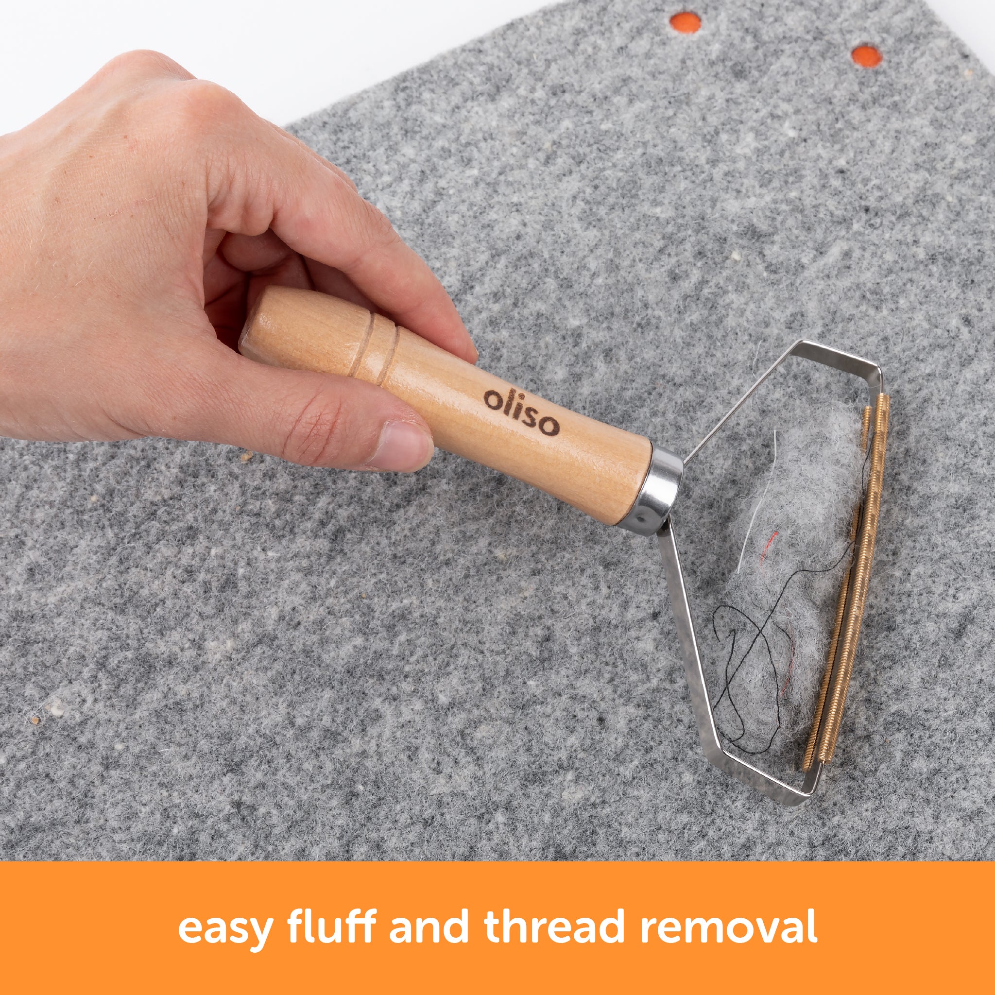 Oliso MultiMat cleaning tool with ergonomic wooden handle and fine metal comb for lifting lint and fibers from wool pressing mats.