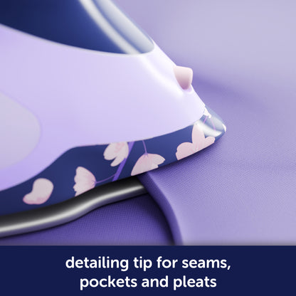 Oliso Yaya Han ProPlus iron in striking Midnight Blue with a unique cherry blossom design and a 2-inch detailing tip for pressing seams. collars, pockets, and pleats -ideal for sewing, quilting, and making cosplay costumes.