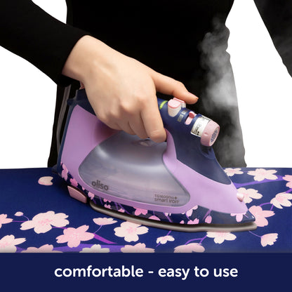 Oliso Yaya Han ProPlus Iron in striking midnight blue with a cherry blossom design. The ergonomic handle offers a comfortable grip, while the auto-lift feature eliminates the need to lift the iron—making pressing safer and less tiring. Perfect for sewing, quilting, and creating cosplay costumes.
