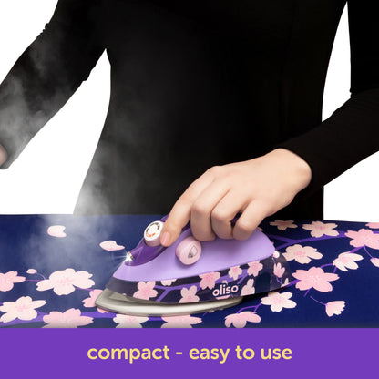 Oliso Yaya Han M3Pro project iron in Midnight Orchid with cherry blossom design, featuring an ergonomic mouse-style handle for easy grip and smooth gliding over fabric—perfect for sewing, quilting, and cosplay costume making.