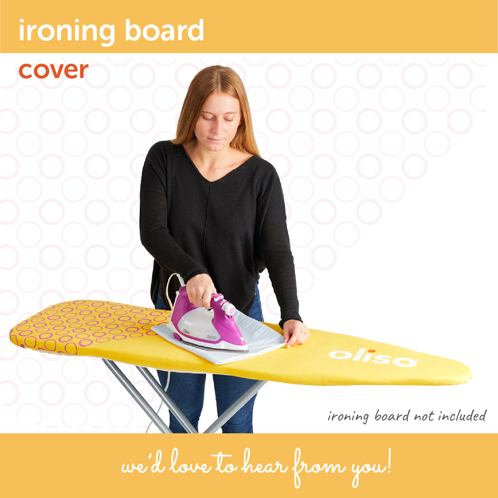 A person pressing fabric with an iron on the yellow and purple Oliso Ironing board cover.